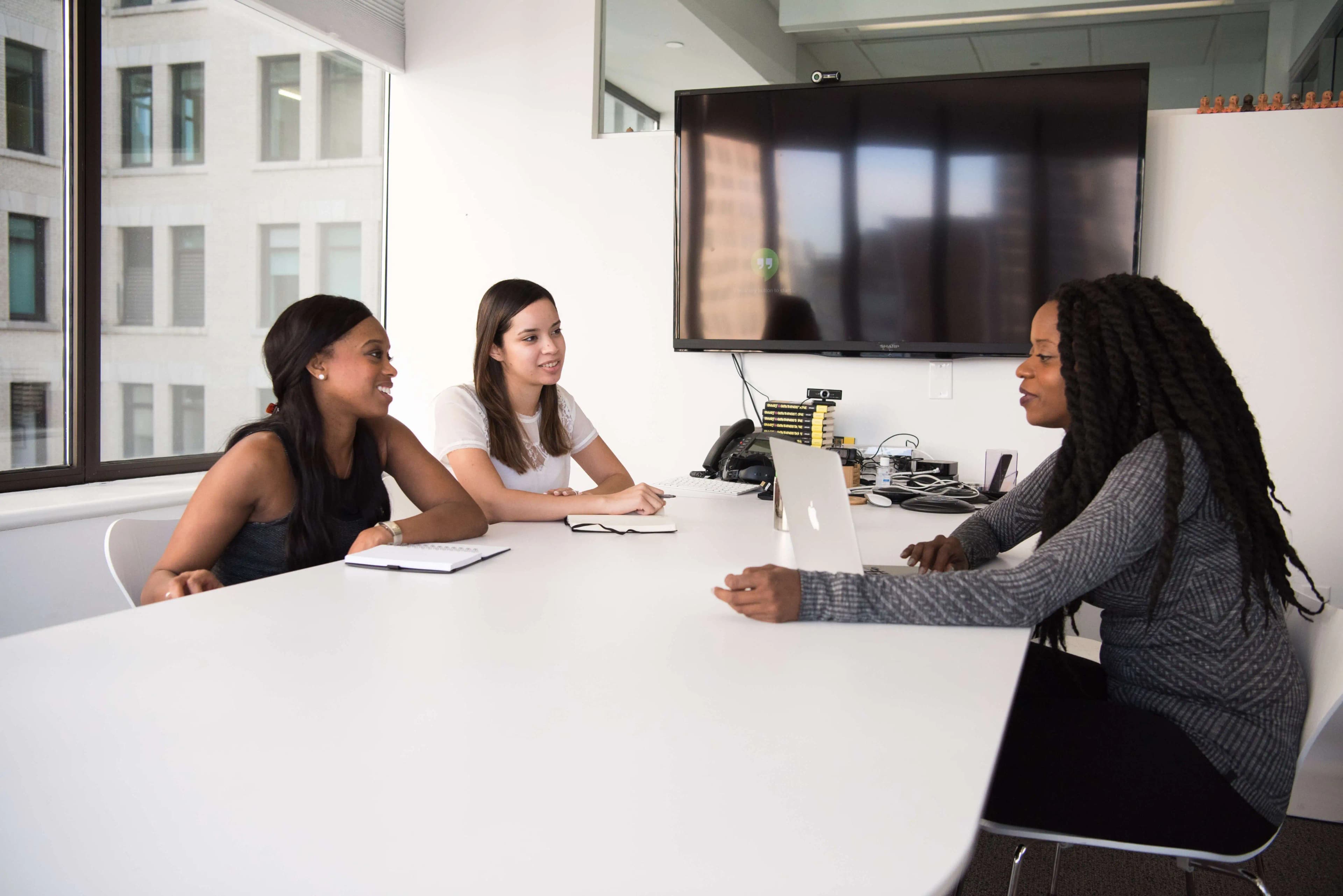 3 girls in a meeting talking